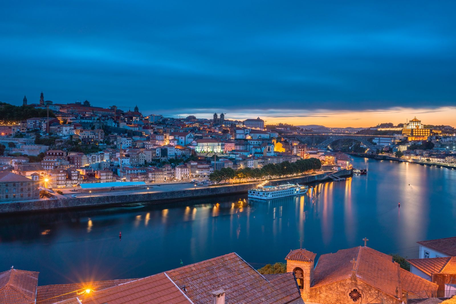 Porto&rsquo;s riverfront lights at dawn over the Douro, where every Douro river cruise Porto departure begins